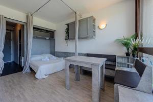 a living room with a table and a couch at Le Chamois - Au pied des Pistes in Villard-de-Lans