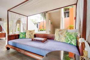 a bed with a canopy in a room with a window at Signature Phuket Resort in Chalong  +57 photos