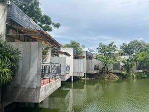 a building next to a body of water at Blue Palm Resort in Bang Sare