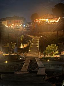 a walkway at night with a building in the background at Baan Rattana in Ko Yao Noi