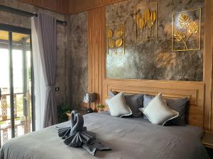 a bedroom with a large bed with a headboard at Baan Rattana in Ko Yao Noi