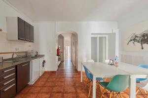 a kitchen with a table and chairs in a room at ThisisLisbon - Apartment & Terrace - 1st in Lisbon