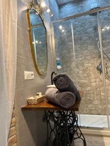 a bathroom with a shower with towels on a table at Il Giardino Segreto in Anagni +37 photos