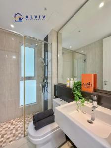 a bathroom with a sink and a toilet and a mirror at NEW! The Shore Residences 3BR Luxury I Direct access to Shopping I 6-10pax I 10minsJonker in Melaka
