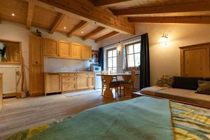 a kitchen and living room with a couch and a table at Kofelhof in Sesto