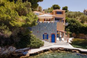 an aerial view of a house with a swimming pool at Porto Castello Villas in Skiathos Town