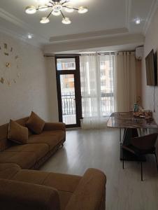 a living room with a couch and a clock on the wall at L10D10- Jasmin Travel in Sumqayyt