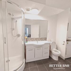 a bathroom with a shower and a sink and a toilet at Affordable Value 3 Cozy Beds 2 Smart Rooms in Lower Hutt +11 photos