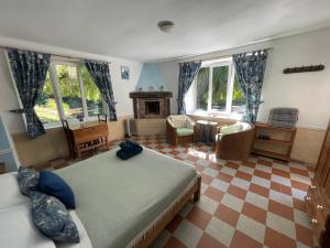 a bedroom with two beds and a fireplace at Le Moulin L'Eveque in Campeaux
