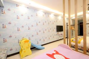 - une chambre pour enfants avec un mur orné d'une fresque murale représentant un bateau pirate dans l'établissement Xingyue Apartment Nimble Huamei Branch, à Canton