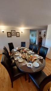 a dining room table with chairs and food on it at Tulin in Wetlina