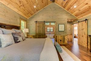 a bedroom in a log cabin with a large bed at Little Creek Cabin - Game Room with Media Space, Outdoor TV Lounge, Hot Tub + Firepit in Blue Ridge