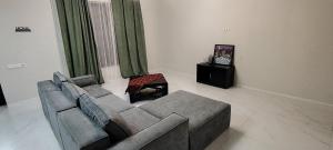 a living room with a couch and a table at Villa Harmony Tianeti in Tʼianetʼi