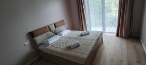 a bed in a room with a large window at Villa Harmony Tianeti in Tʼianetʼi