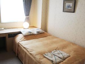Postel nebo postele na pokoji v ubytování ロイヤルイン水戸-旧ホテルトレンド水戸-