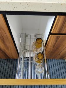 a glass cabinet with three bottles of wine at Homestay Pinggiran Kota Kuantan in Kuantan +34 photos