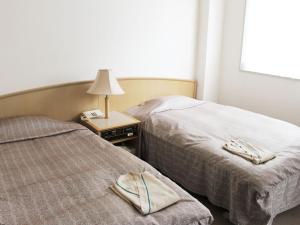 Postel nebo postele na pokoji v ubytování ロイヤルイン水戸-旧ホテルトレンド水戸- + 18 fotografií