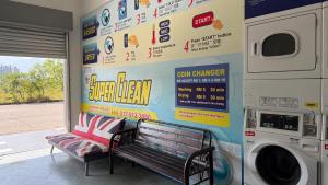 a washing machine and a bench in a laundry room at Summer Hotel Kampar Perak in Kampar