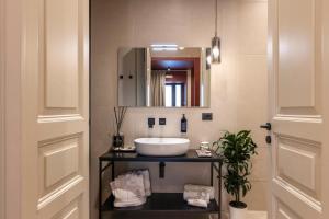 a bathroom with a sink and a mirror at Carmela Homes & Residences in Catania +100 photos