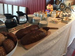 a table with different types of bread on it at Branteviks Bed o Breakfast in Brantevik