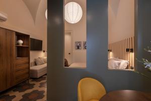 a room with a bedroom with a bed and a table at Carmela Homes & Residences in Catania
