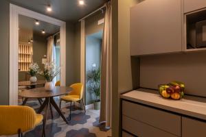a kitchen and dining room with a table and a dining room at Carmela Homes & Residences in Catania