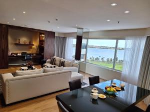 a living room with a couch and a table at Residence on Langley Park in Perth
