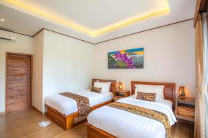 Voodi või voodid majutusasutuse Uma Nandhi Villa Ubud toas