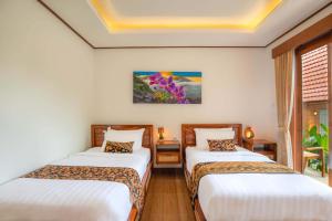 Voodi või voodid majutusasutuse Uma Nandhi Villa Ubud toas