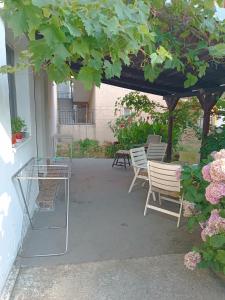 a patio with a table and chairs under a pergola at M6 olive tree studio in Sutomore