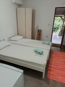 a white bed in a room with a mirror at M6 olive tree studio in Sutomore