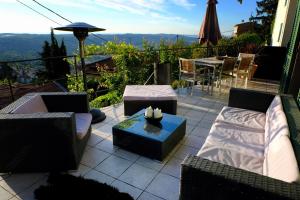 a patio with couches and a table with a view at Skylark Bed & Breakfast in Grasse