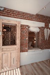 a brick wall with a door in a room at La Whiteroom de l'Artois in Souchez