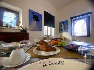 a table with plates of food and fruit on it at Le Cancelle - Residenza d'epoca in LʼAquila