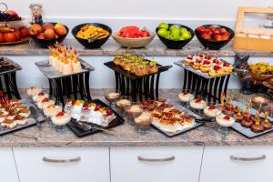 a buffet with many different types of desserts and fruits at Hotel Sunny in Sozopol