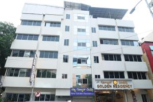 a white building with a sign in front of it at NewGoldenResidency in Bengaluru +15 photos