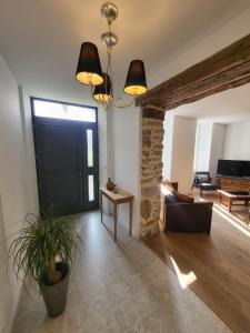 a living room with a black door and a couch at "La maison d'Octavie" in Rieupeyroux