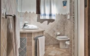 a bathroom with a toilet and a sink at Sea View Grande Pevero 5 in Porto Cervo