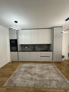 a living room with white cabinets and a rug at Pristina Luxury Apartments 15 in Pristina