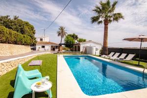 a villa with a swimming pool and a house at Finca Tossalet. Piscina privada y barbacoa in Benissa