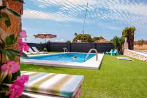 a pool in a yard with a person in it at Finca Tossalet. Piscina privada y barbacoa in Benissa
