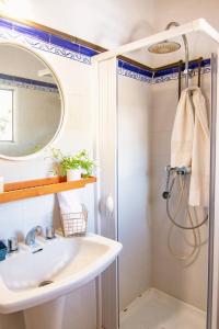 a bathroom with a sink and a shower with a mirror at Finca Tossalet. Piscina privada y barbacoa in Benissa +38 photos