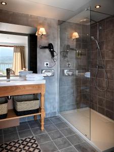 a bathroom with a shower and a sink at Hôtel Beau Site Talloires B SPA in Talloires