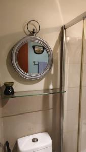 a bathroom with a mirror and a white toilet at Studio Premier Suite Makatii by Christine Suites PH in Manila