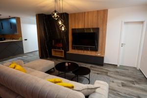 a living room with a couch and a tv at Vila Lara Zvornik in Zeljići