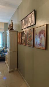 a group of pictures on a wall in a room at Studio Premier Suite Makatii by Christine Suites PH in Manila