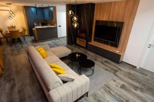 a living room with a couch and a tv at Vila Lara Zvornik in Zeljići