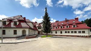 a large red and white building with a tree at GORCZAŃSKA PERŁA Łopuszna Podhale in Łopuszna