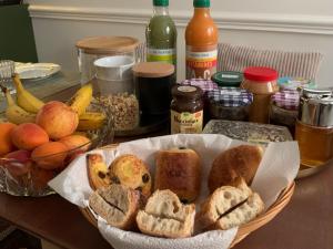 a table topped with a basket of bread and fruit at Chambres d'hôtes - Marais in Paris