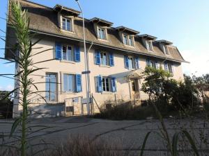 ein großes Gebäude mit blauen Fensterläden darauf in der Unterkunft VINITA Chambres d'hôtes in Boncourt